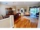 Spacious living room featuring hardwood floors, dining area, and seamless access to a lanai at 4808 Jewell Ter, Palm Harbor, FL 34685