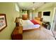 Bright main bedroom featuring a ceiling fan, ample closet space, and a cozy ambiance at 4808 Jewell Ter, Palm Harbor, FL 34685