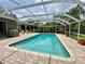 A beautiful screened-in pool area with brick patio, perfect for outdoor entertaining at 4808 Jewell Ter, Palm Harbor, FL 34685