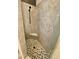 Modern shower featuring neutral tile surround, honeycomb floor and handy corner seat at 4808 Jewell Ter, Palm Harbor, FL 34685