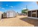 Spacious gravel backyard with a storage shed, offering ample room for outdoor activities at 4842 Odyssey Ave, Holiday, FL 34690