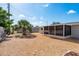 A sunny backyard includes a storage shed and a screened porch that is fenced in at 4842 Odyssey Ave, Holiday, FL 34690