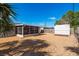 Wide view of the sunny, spacious backyard featuring a storage shed and screened porch at 4842 Odyssey Ave, Holiday, FL 34690