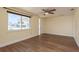 Bedroom featuring laminate floors, ceiling fan, natural light, and neutral-colored walls at 4842 Odyssey Ave, Holiday, FL 34690