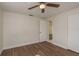 Spacious bedroom with wood-look flooring, closet, and a ceiling fan at 4842 Odyssey Ave, Holiday, FL 34690