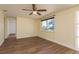 This bedroom offers lots of natural light, a ceiling fan, and laminate floors at 4842 Odyssey Ave, Holiday, FL 34690
