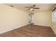 Bright bedroom with a ceiling fan, wood-look flooring, and a large window at 4842 Odyssey Ave, Holiday, FL 34690