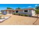 Well-maintained single-story home with light gray paint, rock landscaping, and mature bushes at 4842 Odyssey Ave, Holiday, FL 34690