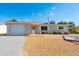Charming single-story home featuring a well-maintained front yard and attached garage at 4842 Odyssey Ave, Holiday, FL 34690