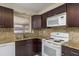 Kitchen boasts granite countertops, updated cabinets, and well-maintained appliances at 4842 Odyssey Ave, Holiday, FL 34690
