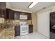 The kitchen features granite countertops, tile floors, and updated appliances at 4842 Odyssey Ave, Holiday, FL 34690