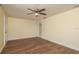 Bright living room featuring wood-look floors and a modern ceiling fan, perfect for relaxing or entertaining at 4842 Odyssey Ave, Holiday, FL 34690