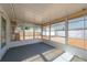 The screened porch has a gray floor, white ceiling, and multiple windows with backyard views at 4842 Odyssey Ave, Holiday, FL 34690
