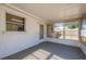 Sun-filled enclosed back porch with bright windows and access to the yard at 4842 Odyssey Ave, Holiday, FL 34690