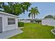 Spacious backyard featuring a lush lawn, storage shed, and mature landscaping, perfect for outdoor activities at 513 Fairhope Dr, Apollo Beach, FL 33572