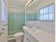 Bathroom featuring tiled shower, vanity, and neutral colors at 513 Fairhope Dr, Apollo Beach, FL 33572