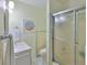 Bathroom featuring a toilet, vanity, and tiled walk-in shower at 513 Fairhope Dr, Apollo Beach, FL 33572