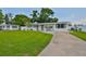 Charming single story home featuring a well-manicured lawn and a concrete driveway at 513 Fairhope Dr, Apollo Beach, FL 33572