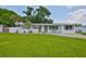 Charming single-story home featuring a manicured lawn, freshly painted exterior, and delightful curb appeal at 513 Fairhope Dr, Apollo Beach, FL 33572