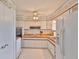 Functional kitchen with white cabinets, updated appliances, and a bright ceiling fan for added comfort at 513 Fairhope Dr, Apollo Beach, FL 33572