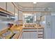 Bright kitchen with white cabinets, updated appliances, and a window overlooking the serene outdoors at 513 Fairhope Dr, Apollo Beach, FL 33572