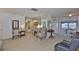 Open-concept living room with neutral carpet, leading into the dining area, offering a bright and airy feel at 513 Fairhope Dr, Apollo Beach, FL 33572