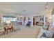 Spacious living room showing neutral carpet, ample seating, and seamless transitions to the dining area and den at 513 Fairhope Dr, Apollo Beach, FL 33572