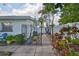Whimsical, tropical oasis with wrought iron gate and vibrant landscaping, a secret garden escape at 513 Fairhope Dr, Apollo Beach, FL 33572