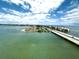 Beautiful aerial view of the coastal community, showing bridges and waterfront property under a bright blue cloudy sky at 5220 Brittany S Dr # 1306, St Petersburg, FL 33715