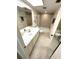 Bright bathroom features a single sink, vanity with white cabinets, and tiled shower and tub enclosure at 5220 Brittany S Dr # 1306, St Petersburg, FL 33715
