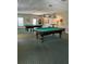 Billiard room with two pool tables, patterned carpet and overhead lighting at 5220 Brittany S Dr # 1306, St Petersburg, FL 33715