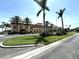 Exterior view of the community clubhouse, lush landscaping, and mature palm trees at 5220 Brittany S Dr # 1306, St Petersburg, FL 33715
