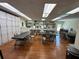 Large craft room featuring worktables, cabinets, wooden floors, and natural light at 5220 Brittany S Dr # 1306, St Petersburg, FL 33715