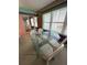 Dining room features a glass table, white chairs, blinds, and colorful walls at 5220 Brittany S Dr # 1306, St Petersburg, FL 33715
