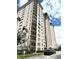 Upscale high-rise residential building featuring multiple balconies and parking area in front at 5220 Brittany S Dr # 1306, St Petersburg, FL 33715