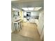 Traditional kitchen with white appliances, tile flooring and breakfast bar with seating at 5220 Brittany S Dr # 1306, St Petersburg, FL 33715