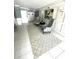 Lobby area with patterned rug, seating, artwork, paneled walls and white tiled flooring at 5220 Brittany S Dr # 1306, St Petersburg, FL 33715