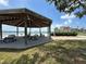 Open-air pavilion with picnic tables, BBQ grills, and waterfront views at 5220 Brittany S Dr # 1306, St Petersburg, FL 33715