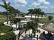 Lovely community pool and tropical grounds with palm trees and beach access at 5220 Brittany S Dr # 1306, St Petersburg, FL 33715