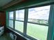 Scenic view of a waterfront community from a large window with blinds and sheers at 5220 Brittany S Dr # 1306, St Petersburg, FL 33715