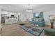 Open-concept living room with modern decor, and view to kitchen and stainless steel appliances at 5229 Chaney Ter, Port Charlotte, FL 33981