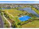 Aerial view of a community park, featuring a lake, playground, basketball court and green spaces at 5810 Fieldmoor Ct, Palmetto, FL 34221