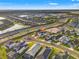 A high altitude aerial view of a neighborhood featuring green spaces and a small lake at 5810 Fieldmoor Ct, Palmetto, FL 34221