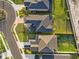 Aerial shot showcasing three properties with well-manicured lawns, driveways, and dark grey roofs at 5810 Fieldmoor Ct, Palmetto, FL 34221