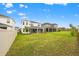 Spacious backyard with well-maintained lawn and screened-in patios in a residential neighborhood at 5810 Fieldmoor Ct, Palmetto, FL 34221