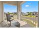 Charming balcony seating with a view of the residential streetscape and neighborhood homes at 5810 Fieldmoor Ct, Palmetto, FL 34221