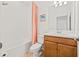 Cozy bathroom featuring a bathtub and shower combination, single vanity with storage, and bright lighting at 5810 Fieldmoor Ct, Palmetto, FL 34221