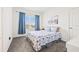 Cozy bedroom with a large window, soft carpet, and a comfortable bed with attractive blue and white bedding at 5810 Fieldmoor Ct, Palmetto, FL 34221