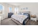 Bright bedroom featuring large windows, plush carpet, and a comfortable bed with stylish bedding at 5810 Fieldmoor Ct, Palmetto, FL 34221
