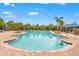 Inviting community pool with palm trees and lounge chairs on a sunny day at 5810 Fieldmoor Ct, Palmetto, FL 34221